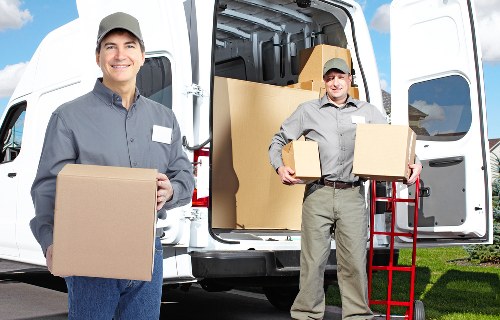 Local movers loading boxes into a van near Highgate homes