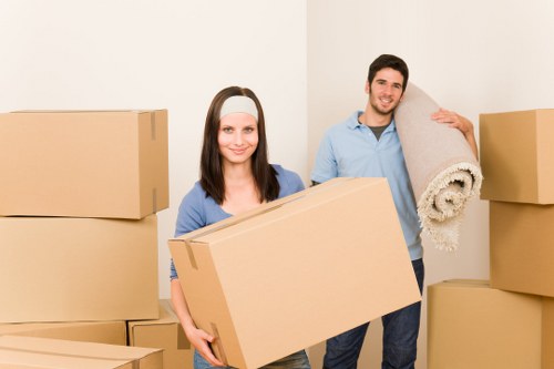 Local movers carrying furniture through a residential street